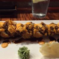 Godzilla Roll · Tuna, salmon, crab stick and avocado whole roll tempura with sweet sauce, and spicy sauce.