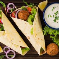 Falafel Wrap · Served with crispy homemade falafel, vt, feta cheese, cucumbers, and low-fat tahini sauce.