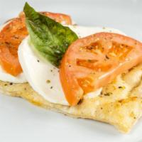 Crispino Pie · Sliced tomato, homemade fresh mozzarella, fresh basil on garlic-seasoned pizza crust.
