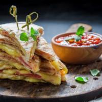 The Pastrami & Bacon Quesadilla · Quesadilla made with Pastrami, crispy bacon strips, melted cheese, green peppers, and red on...