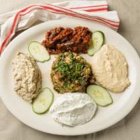 Mixed Cold Appetizers · Hummus, ­tabbouleh, lebni, baba ganoush, ­and eggplant with tomato sauce.