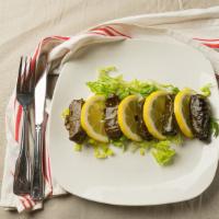 Stuffed Grape Leaves · 6 grape leaves stuffed with rice, dry mint, black pepper, and onions.