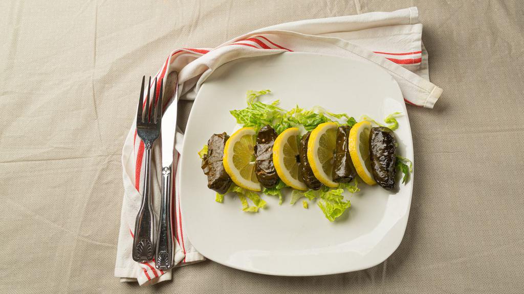 Stuffed Grape Leaves · 6 grape leaves stuffed with rice, dry mint, black pepper, and onions.