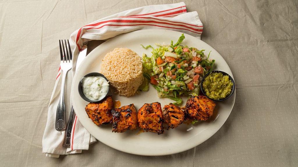 Grilled Chicken · 5 grilled cubes of chicken breast marinated with yogurt, cilantro, corn oil, pepper paste, tomato paste, salt, black pepper, and dry oregano. Served with white basmati rice, salad, yogurt sauce, and hot sauce on the side.