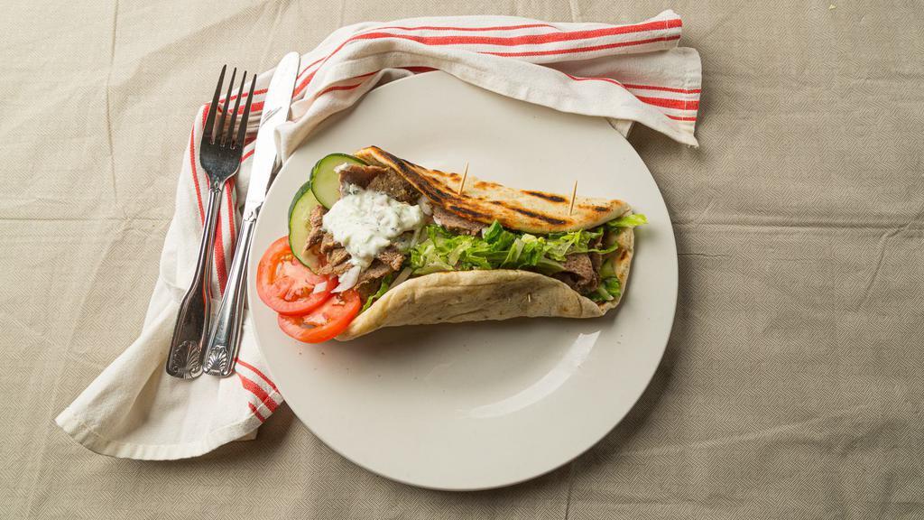 Lamb And Beef Gyro Sandwich · Ground lamb, beef mixed with onion, cumin, black pepper, salt vertically grilled, sliced very thin topped with lettuce, tomato, and onion. Served with yogurt sauce and hot sauce on the side.