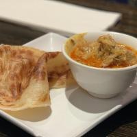 Roti Canai · Spicy. A Malaysian classic. Thick and buttery Indian pancake served with chicken curry sauce.