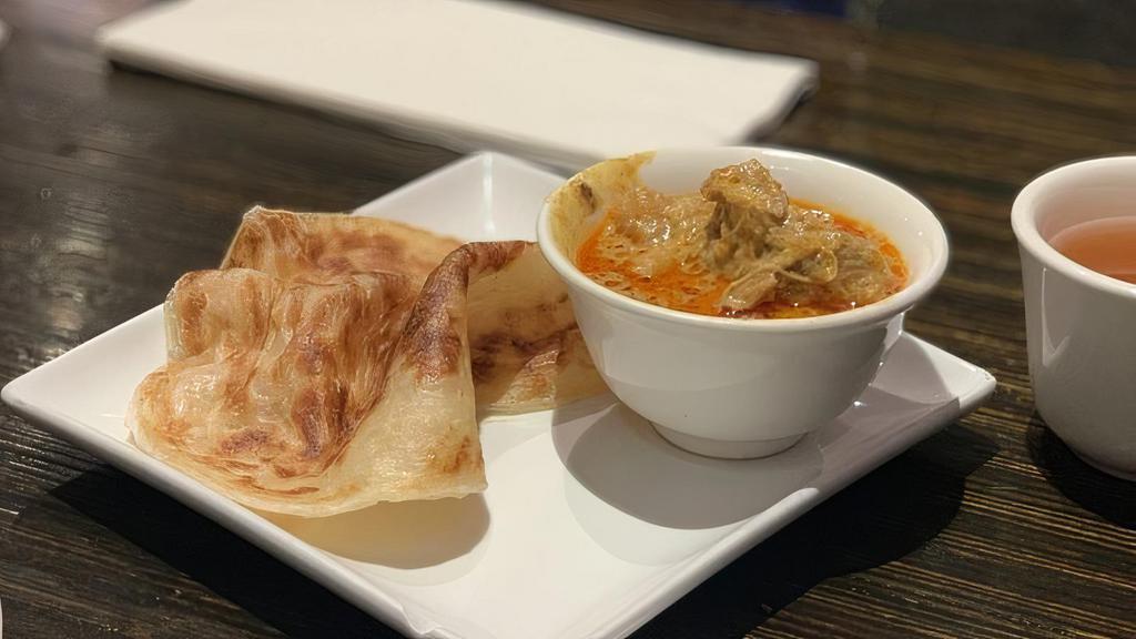 Roti Canai · Spicy. A Malaysian classic. Thick and buttery Indian pancake served with chicken curry sauce.