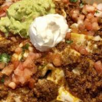 Nachos · All nachos are served with beans, cheese, pico de gallo sour cream, and guacamole.