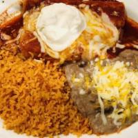 Enchiladas · Two corn tortillas stuffed with your choice of meat, covered with red or green sauce and che...