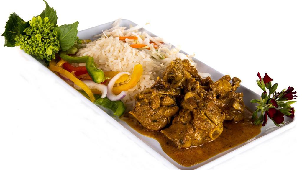 Curried Chicken · This is curry with a little kick. Bite-sized pieces of chicken (with bones cause that's the way we eat it in JA) cooked to a tender doneness and accompanied by white rice or rice and peas. All meals are finished off with our wonderful side of our cabbage and carrot mix.