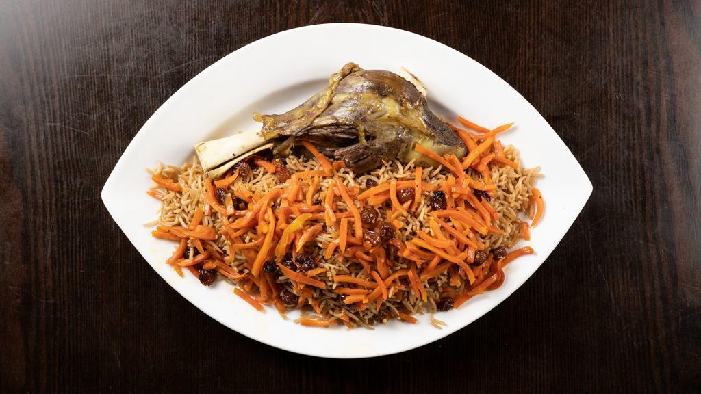 Qabuli Palow · Traditional afghan brown rice over lamb shank topped with raisins and carrots served with garden salad.