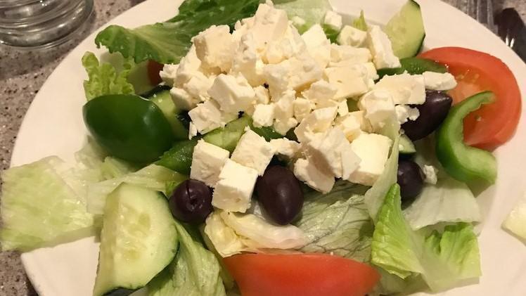 Greek Salad · Mixed greens, anchovies, feta cheese, black olives, tomatoes, green peppers, onions, and grape leaves.