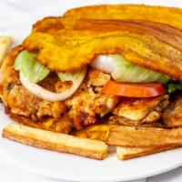 Platano Sandwich De Pollo · Grilled Chicken On A Fried flattened green plantains instead of bread Topped Lettuce Tomato.