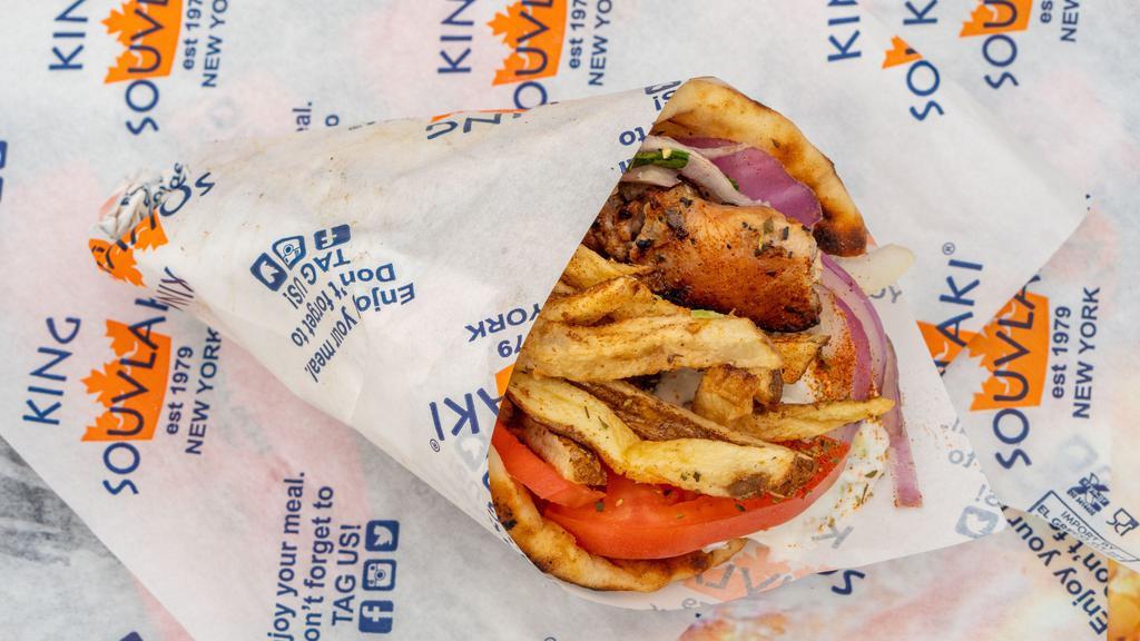 Chicken Souvlaki Pita Sandwich · Perfectly grilled chicken souvlaki wrapped inside of a warm and toasty pita with fillings of your choice.
