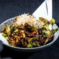 Crispy Brussels Sprouts · Balsamic soy reduction, toasted almonds, green onions, topped with bonito flakes