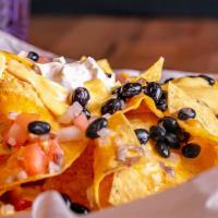 Nachos · Corn tortilla chips covered with chedder cheese pico de garlic ,black beans,jalapenos and so...
