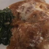 Veal Saltimbocca · Sage butter, prosciutto and mozzarella on a bed of sautéed spinach.