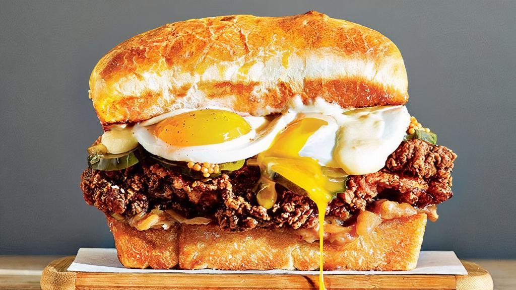 Sultan Of Swat Burger · ½ Pound Burger, Cheddar Cheese, Fried Egg, Lettuce, Tomato, Uptown Sauce on a Brioche Bun.