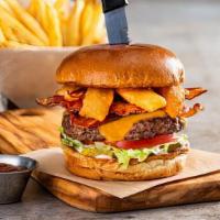 Southern Bbq Burger · 1/2 pound burger, cheddar cheese, bacon, onion rings, lettuce tomato, and BBQ sauce on a bri...