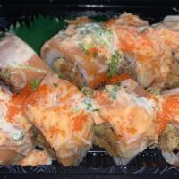 Sunrise Roll · Spicy salmon, avocado inside, topped with kani salad, pepper salmon, caviar, scallion with s...