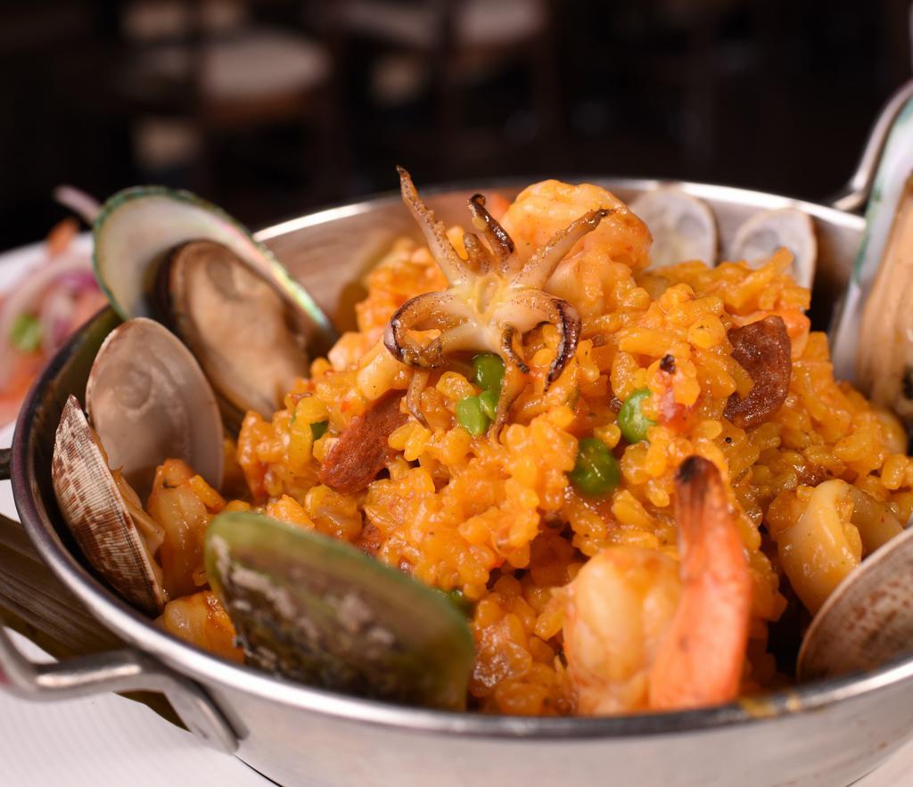 Paella Matíz · Saffron rice mixed with mussels, clams, shrimp, calamari, scallops, green peas, Spanish chorizo (sausage) & chicken.