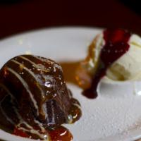 Volcan De Chocolate · Chocolate lava cake with caramel and dulce de leche melting heart served with a scoop of ice...