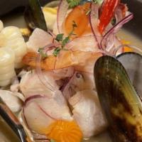 Ceviche Mixto · Peruvian style seafood marinated in lemon juice, served with potato and corn.