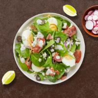 Spill The Spinach Salad · Bed of baby spinach with selected toppings.