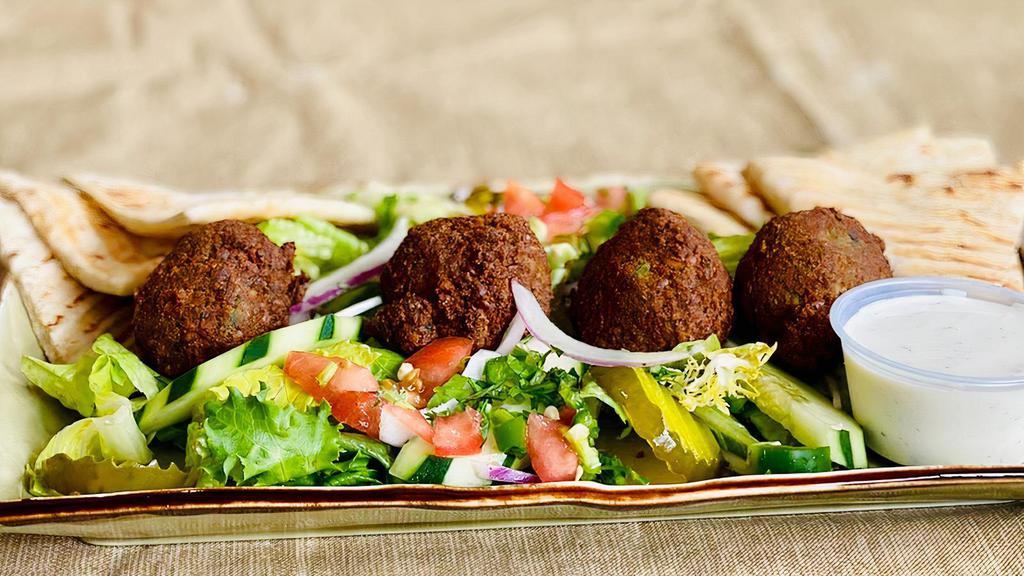Falafel Platter  · Falafel platter it comes with 4pcs veggie falafel, toasted pita bread with homemade salad and tahini sauce or Choice of dressing .