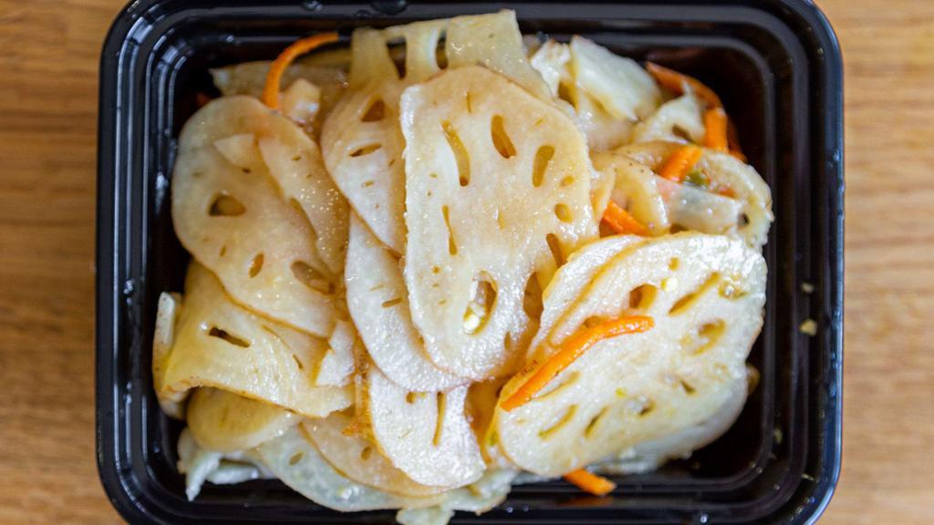 Pickled Lotus Roots · Blanched lotus root slices and shredded carrots, pickled in a rice vinegar brine.