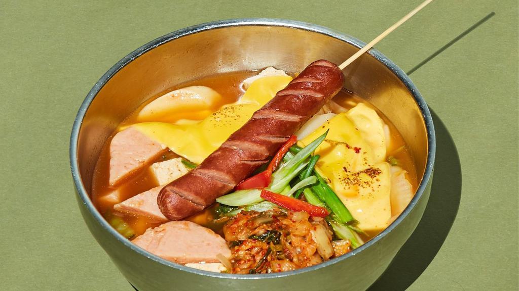 Frat Boy 부대라면 · A spin on the infamous army stew. Ramen with kimchi, spam, cheese, tofu and hot dog on a stick. Soup and noodles packaged separately.