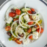 Traditional Horiatiki · Diced tomatoes, cucumbers, red onions, olives, feta, green peppers, and oregano.