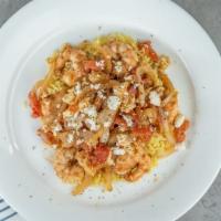 Shrimp Santorini · Pan-fried shrimp in olive oil with onions, diced tomatoes, and feta cheese over rice topped ...
