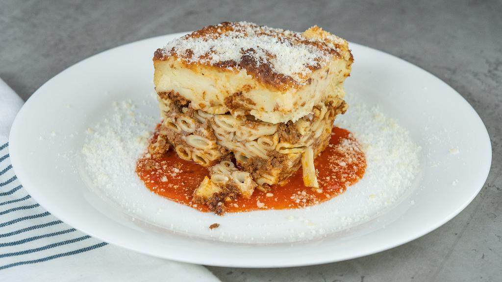 Homemade Pastichio · Traditional baked Greek dish with layers of noodles and meat sauce topped with a baked bechamel sauce.
