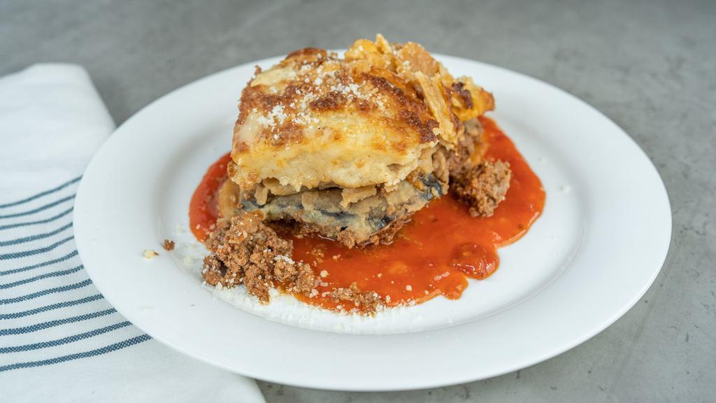Homemade Moussaka · Layers of potato, eggplant, and greek-style meat sauce topped with a béchamel and baked to a golden brown.