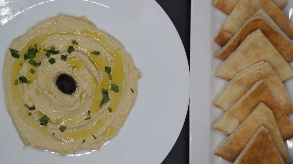 Hummus · Smooth spread, blend of softened ground chickpeas, tahini sauce , olive oil , garlic, a hint of lemon and other indigenous spices served with pita.