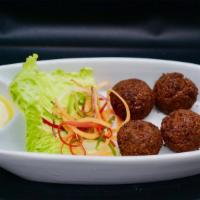 Falafel · Freshly fried patties of ground chickpeas, fresh herbs and spices topped with a drizzle of t...