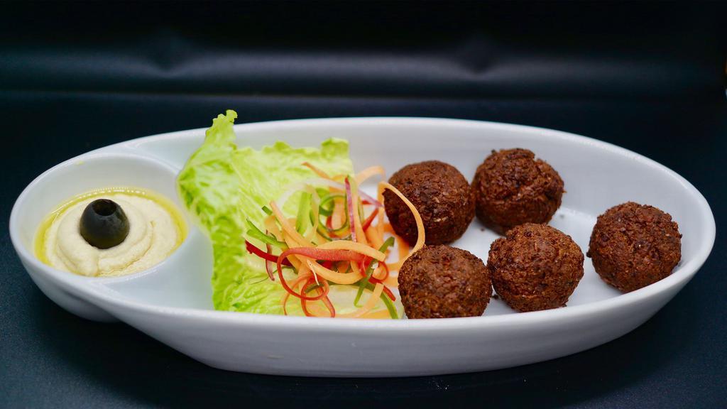 Falafel · Freshly fried patties of ground chickpeas, fresh herbs and spices topped with a drizzle of tahini, served with Tzatziki sauce.