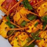 Clay Oven Paneer Tikka · Indian cottage cheese marinated in yoghurt and spices, skewered with green pepper, onions, g...