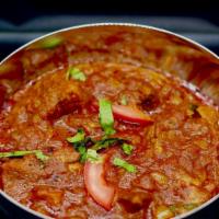 Nadan Chicken Curry Shareable · Medium chicken pieces simmered in a flavorful curry paste with caramelized onions, garlic gi...