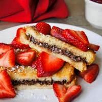 Stuffed Nutella French Toast · Two Thick slices French toast stuffed with Nutella® and topped with sliced strawberries.