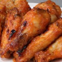 Sriracha Mango Wings · Eight seasoned bone-in or boneless wings fried to perfection and tossed in our signature Sri...
