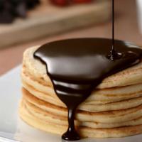 Chocolate Pancakes · Fluffy pancake stack topped with chocolate chips, butter and syrup.