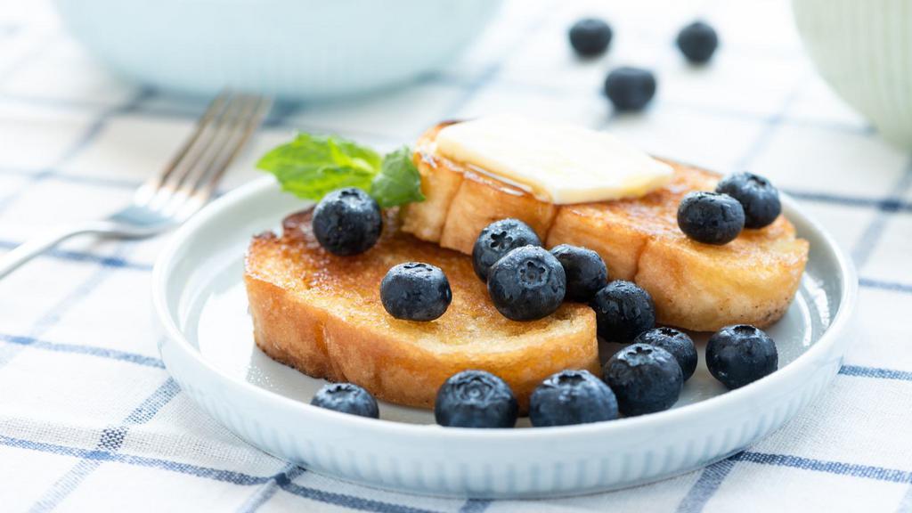 Blueberry French Toasts · Fluffy cut French toasts topped with blueberries, syrup and powdered sugar.