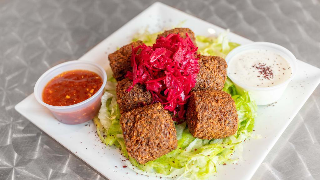 Falafel Platter · 5 pieces of falalfel served yellow rice and choice of 3 toppings. sauce tahini sauce White sauce