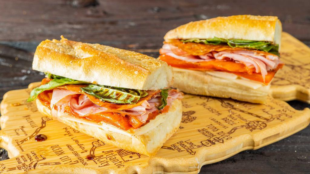 Super Italian Hero · With imported capicola, Hormel pepperoni, hot ham, imported provolone, marinated red roasted peppers, fresh basil, balsamic vinegar and virgin olive oil.