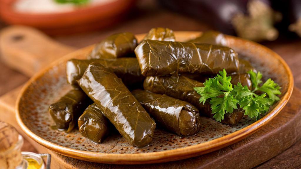 Warak Areesh (Grape Leaves) · Tender, stuffed grape leaves filled with aromatic rice, chickpeas, tomatoes and herbs. Drizzled with lemon juice and olive oil.