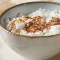 Riz Bi Hale (Rice Pudding) · Classic Lebanese rice pudding drizzled with orange blossom water and sweet syrup. Topped wit...