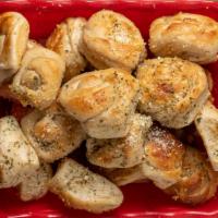 Garlic Knots (4) · A classic snack, our garlic knots are strips of pizza dough tied in a knot, baked, and then ...