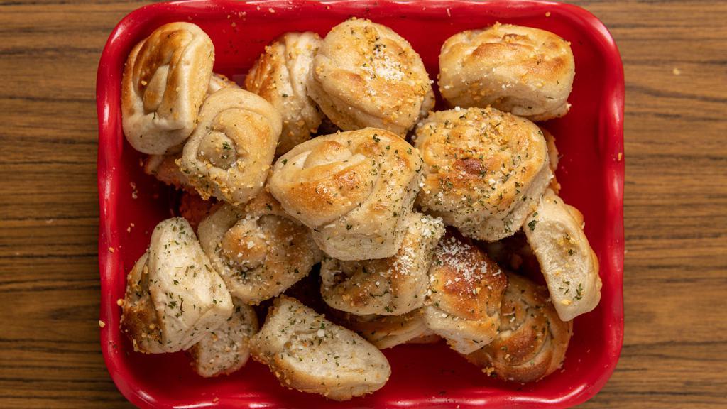 Garlic Knots (4) · A classic snack, our garlic knots are strips of pizza dough tied in a knot, baked, and then topped with melted butter, garlic, and parsley.